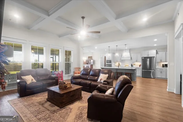 a bedroom with a bed and a flat tv screen on dresser