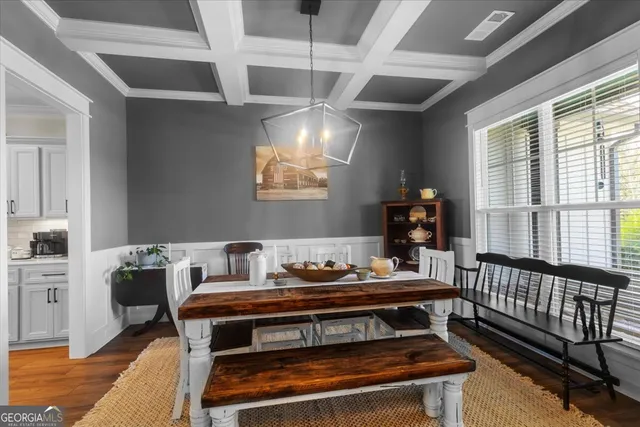 a living room with furniture a flat screen tv and a table