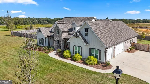 an aerial view of residential houses with outdoor space and ocean view
