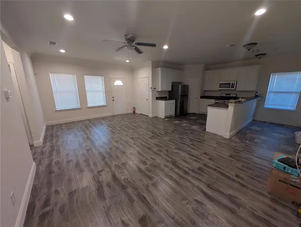 a view of kitchen with cabinets and wooden floor