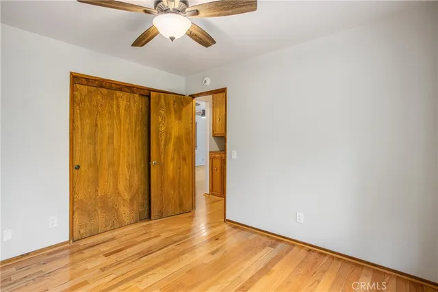 a view of an empty room with window and closet