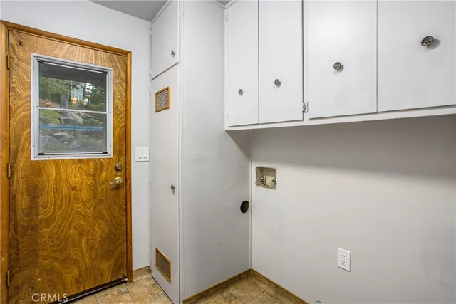 a view of a livingroom with furniture and a window