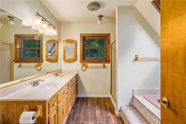 a bathroom with a tub and a window