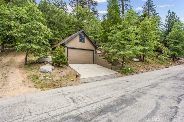 a view of a kitchen with wooden floor and stainless steel appliances