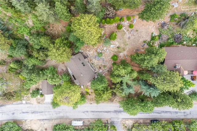 a view of a house with brick walls and a flower garden