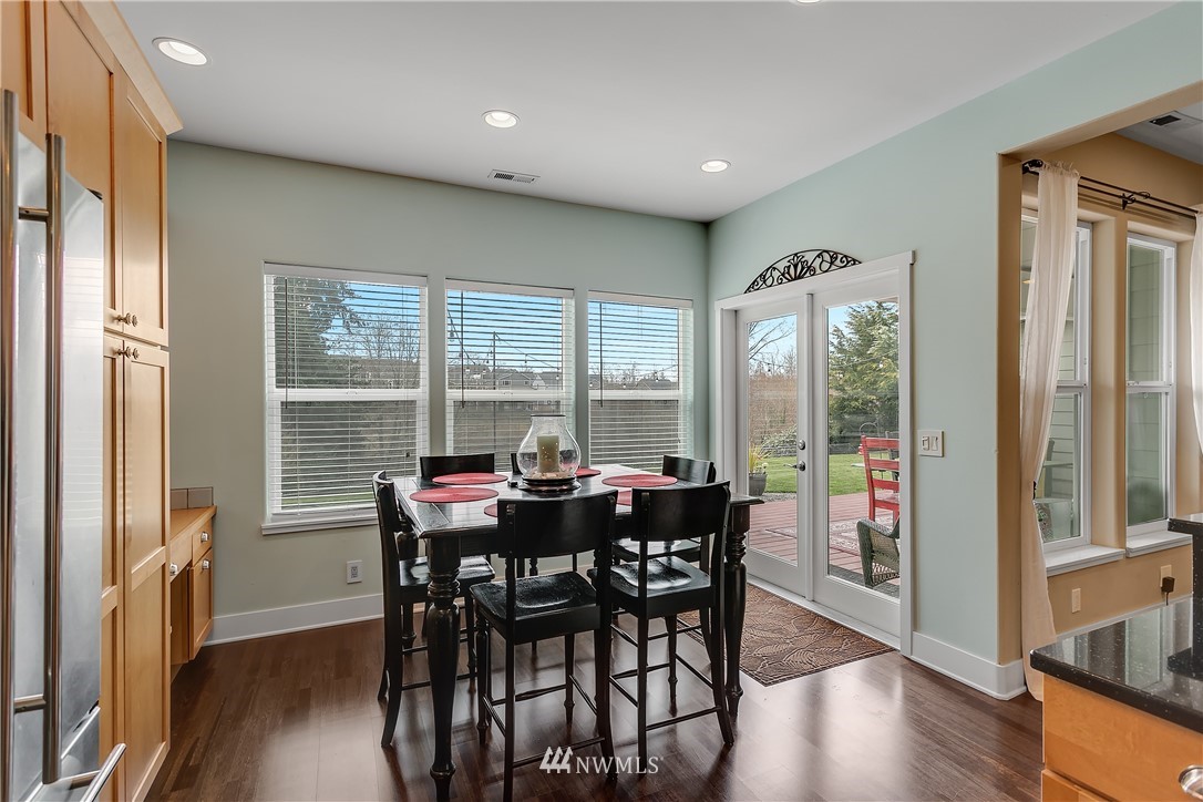 5615 Northeast 10th Street Renton, WA 98059 - Photo 11 of 35 a view of a dining room with furniture window and wooden floor