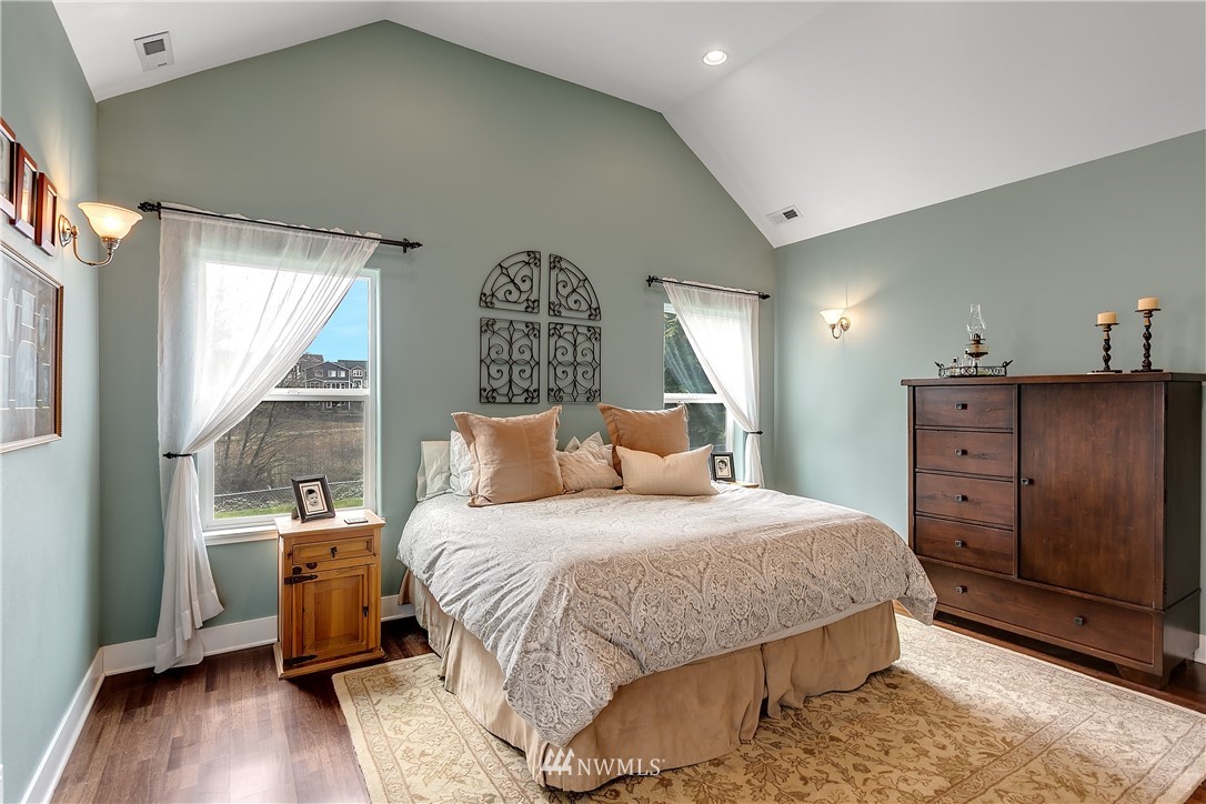 5615 Northeast 10th Street Renton, WA 98059 - Photo 12 of 35 a bedroom with a bed and wooden floor