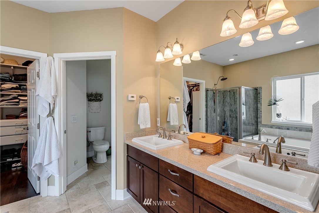 5615 Northeast 10th Street Renton, WA 98059 - Photo 14 of 35 a bathroom with a sink a toilet and a mirror