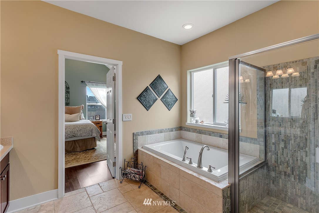 5615 Northeast 10th Street Renton, WA 98059 - Photo 15 of 35 a bathroom with a tub and shower