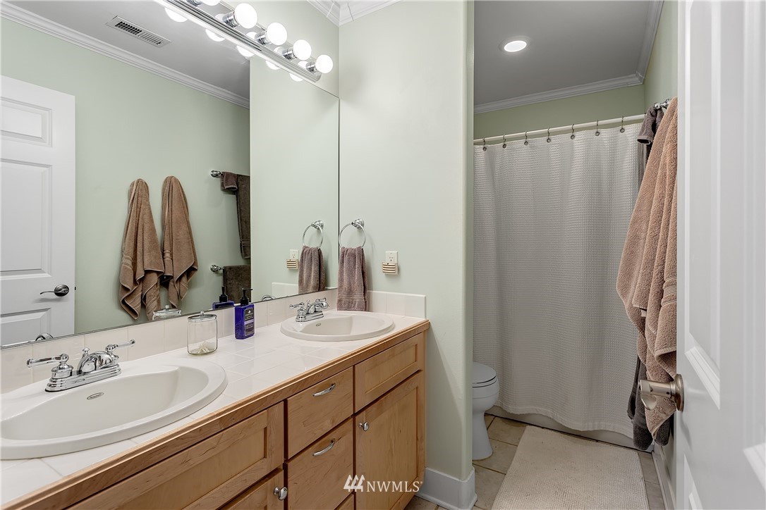 5615 Northeast 10th Street Renton, WA 98059 - Photo 20 of 35 a bathroom with double vanity sink and a mirror