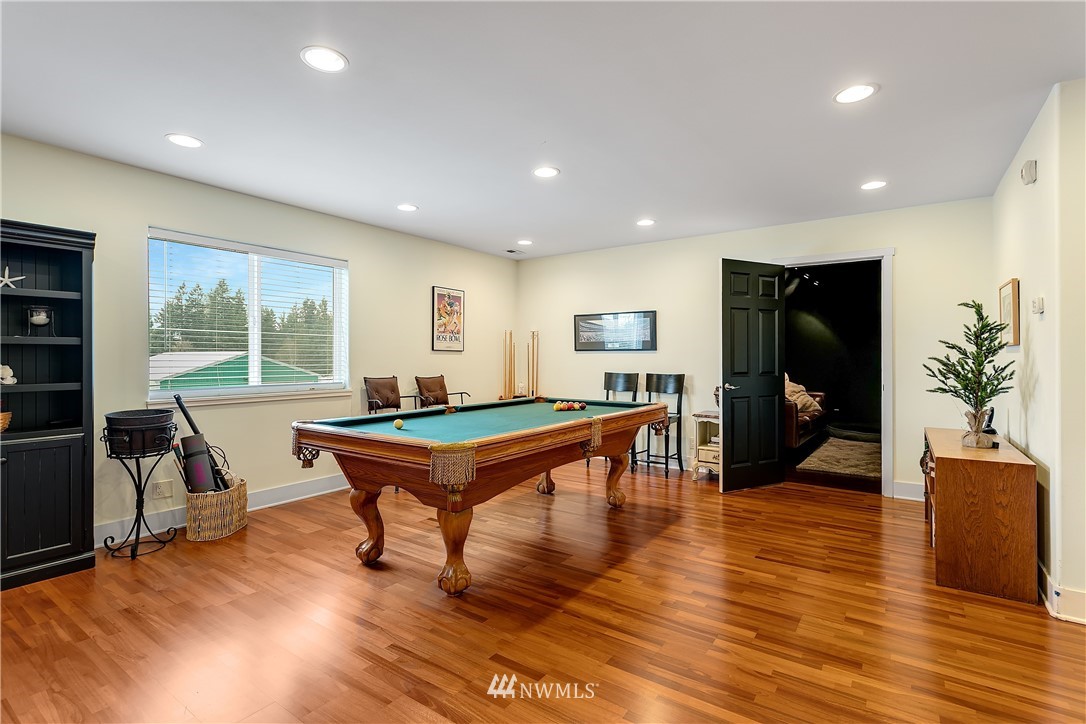5615 Northeast 10th Street Renton, WA 98059 - Photo 22 of 35 a living room with furniture a table and wooden floor