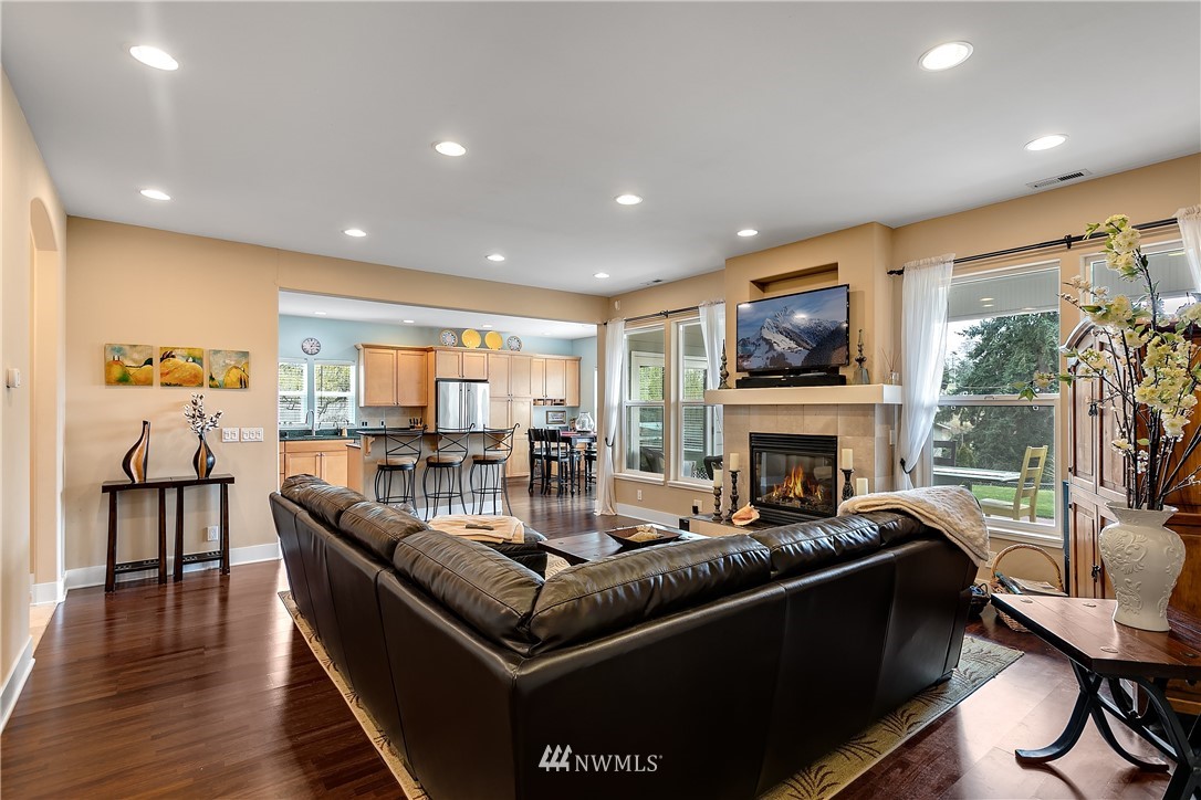 5615 Northeast 10th Street Renton, WA 98059 - Photo 4 of 35 a living room with furniture a fireplace and a flat screen tv