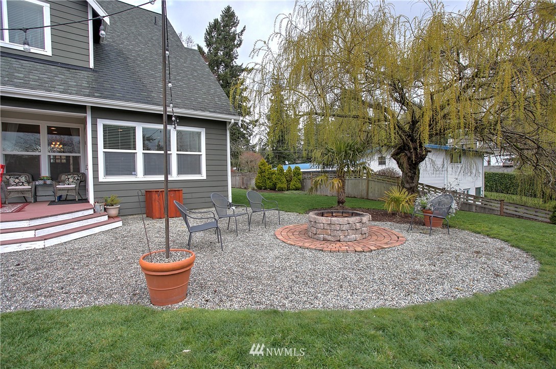 5615 Northeast 10th Street Renton, WA 98059 - Photo 34 of 35 a view of a house with backyard sitting area and garden