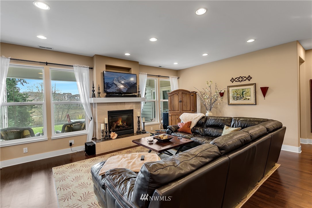 5615 Northeast 10th Street Renton, WA 98059 - Photo 5 of 35 a living room with furniture large window and a fireplace