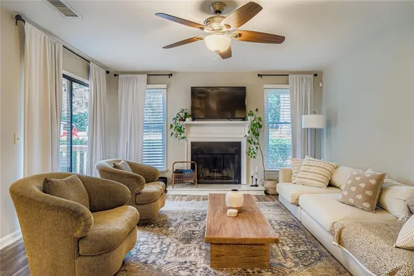 a living room with furniture fireplace and flat screen tv