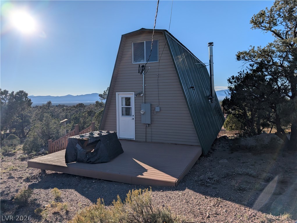 20502 Windsong Road Pioche, NV 89043 - Photo 14 of 30 An elevated wood deck spans the front of this unique A-frame cabin.