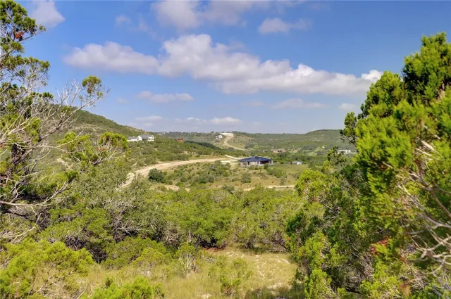 a view of a lake with houses in the back