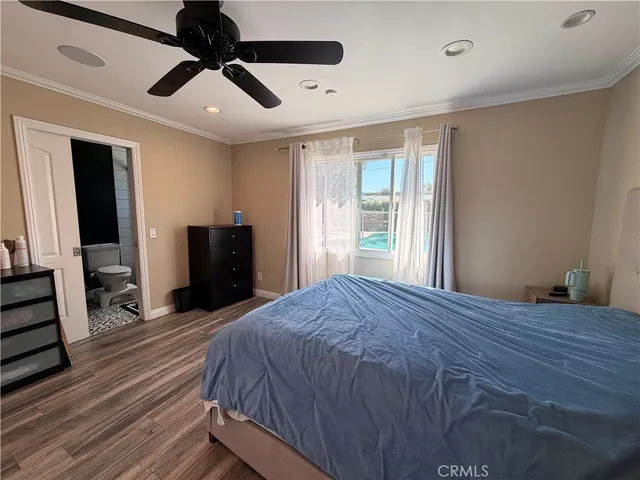 a bedroom with a bed closet and a large window