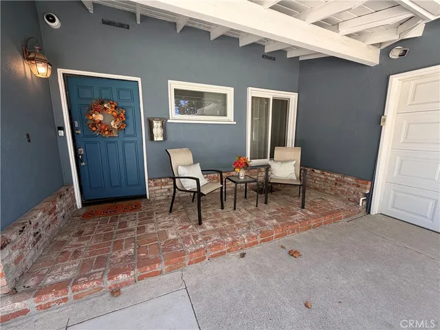a living room with furniture a rug and wall painting