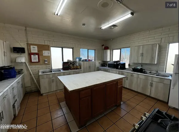 a kitchen with a sink a counter top space a stove and cabinets