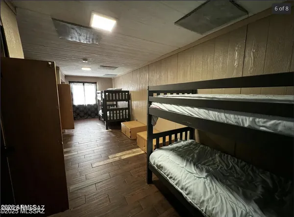 a spacious bedroom with a bed and a book shelf
