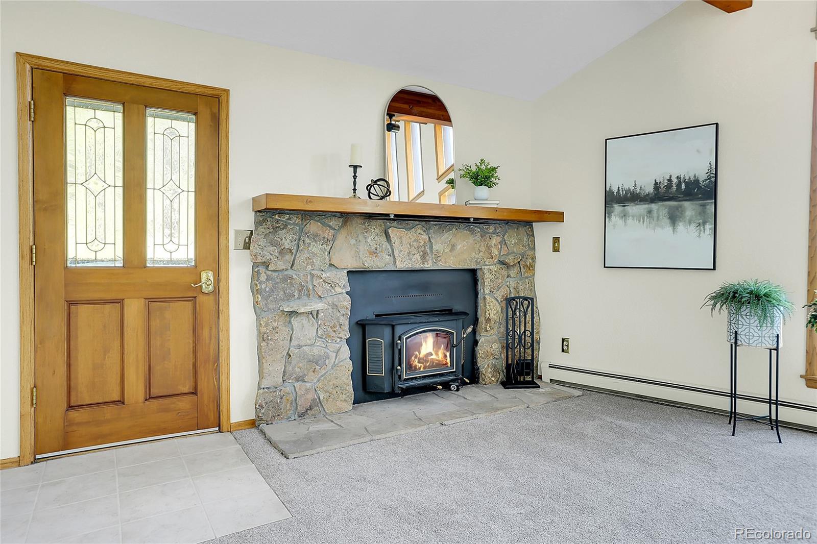 11333 Conifer Mountain Road Conifer, CO 80433 - Photo 14 of 50 a living room with a fireplace and potted plants