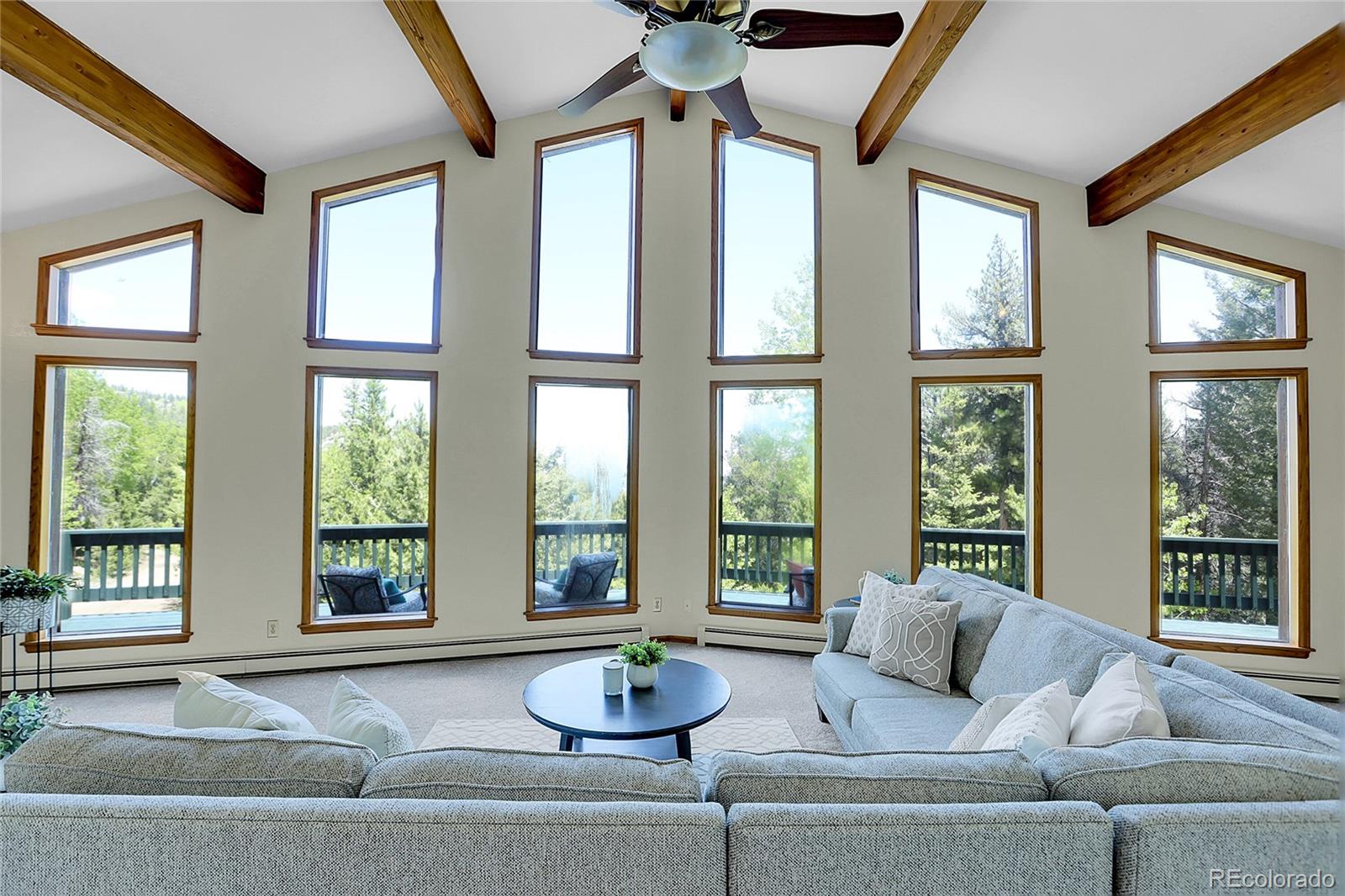 11333 Conifer Mountain Road Conifer, CO 80433 - Photo 15 of 50 a living room with furniture and floor to ceiling windows