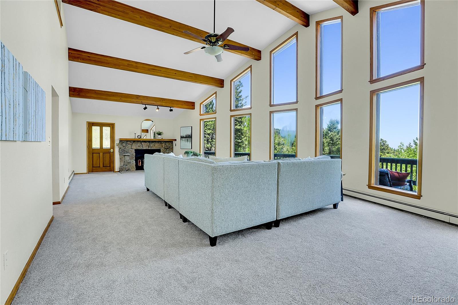 11333 Conifer Mountain Road Conifer, CO 80433 - Photo 16 of 50 a living room with furniture and a large window