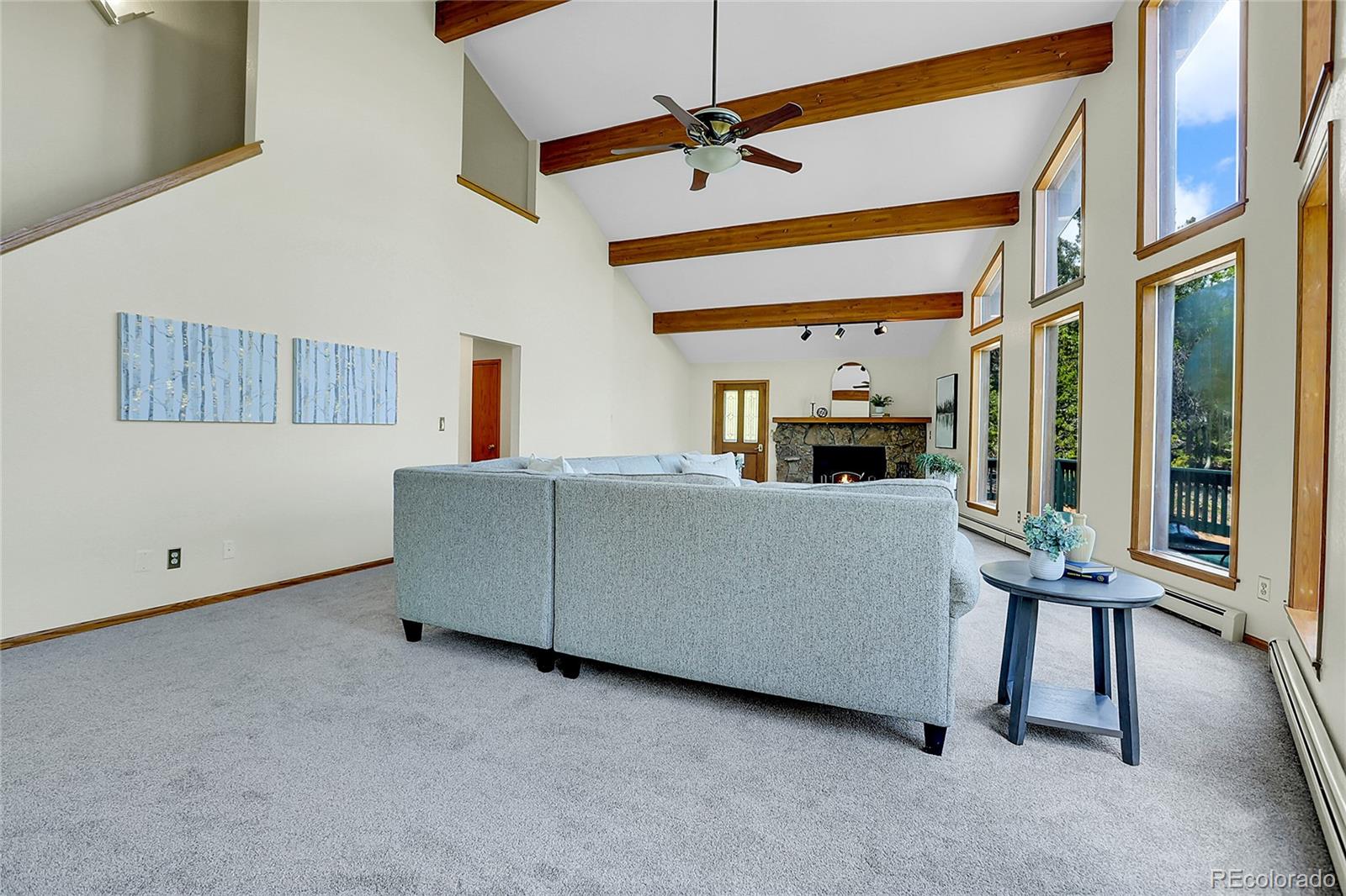 11333 Conifer Mountain Road Conifer, CO 80433 - Photo 17 of 50 a living room with furniture and a chandelier