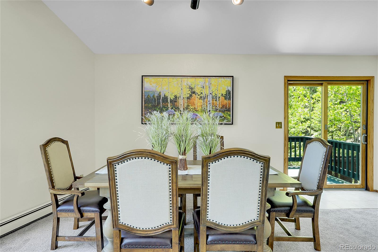 11333 Conifer Mountain Road Conifer, CO 80433 - Photo 19 of 50 a view of a dining room with furniture and a window