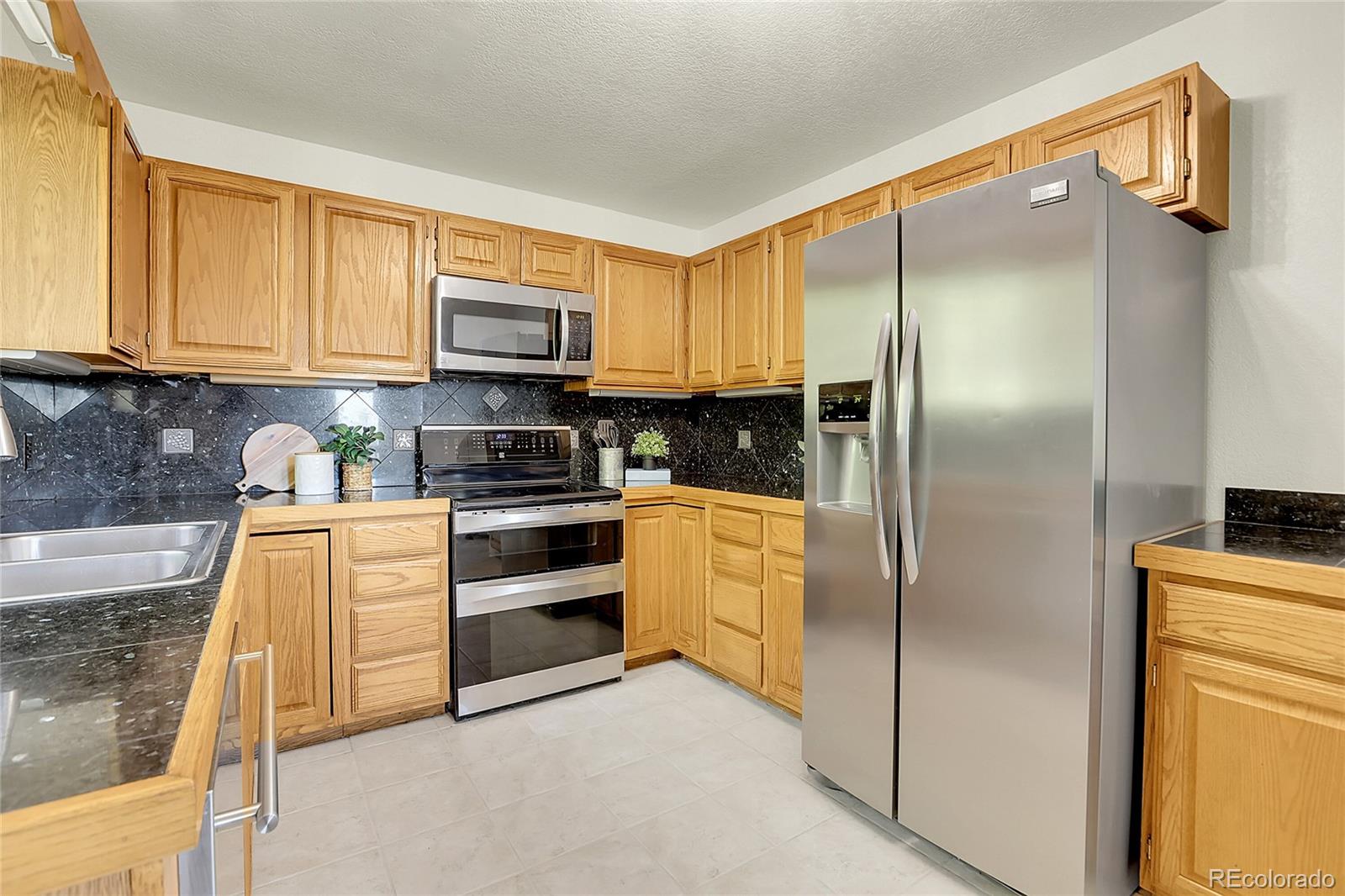 11333 Conifer Mountain Road Conifer, CO 80433 - Photo 23 of 50 a kitchen with stainless steel appliances cabinets a microwave and a sink