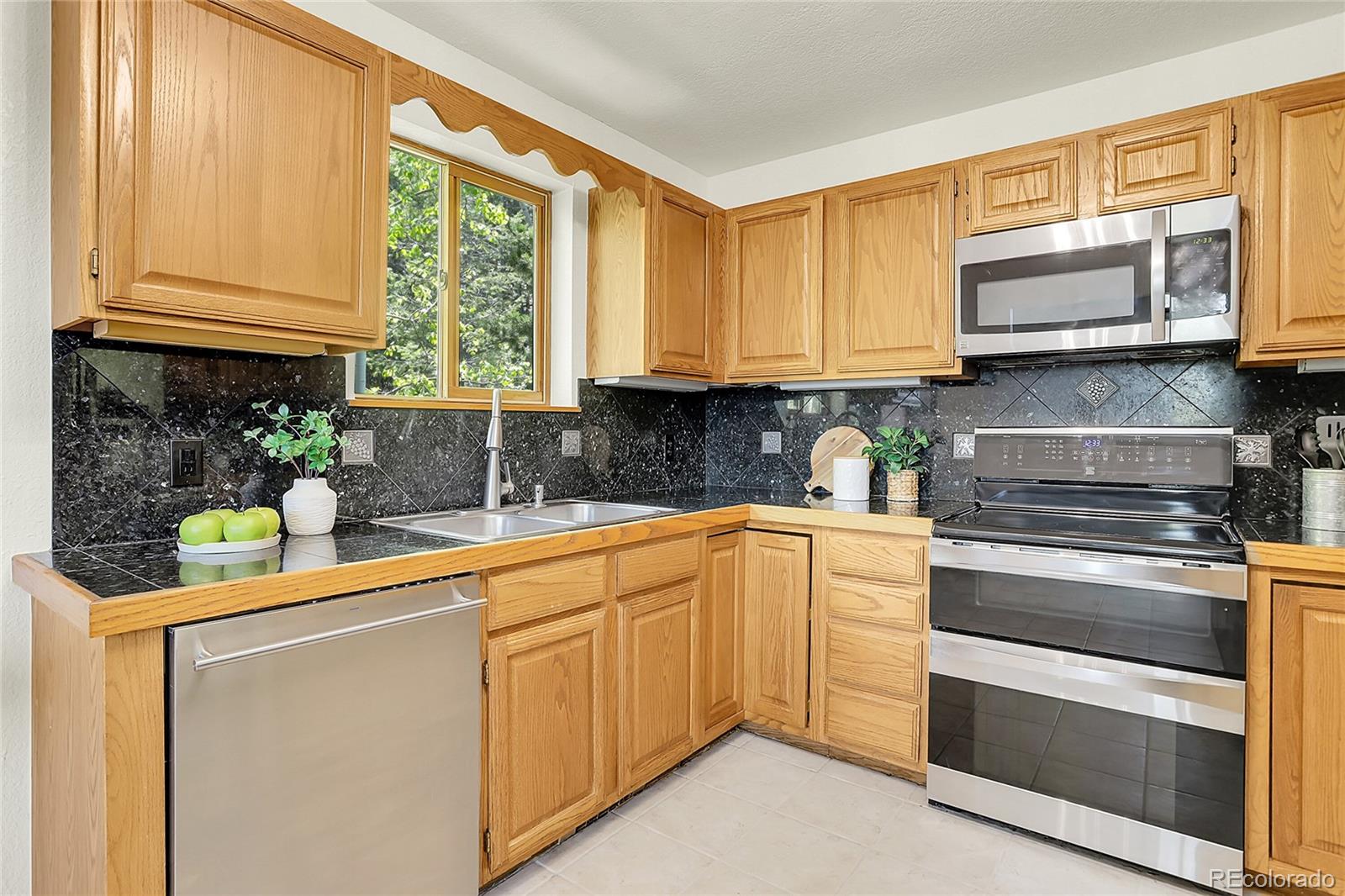 11333 Conifer Mountain Road Conifer, CO 80433 - Photo 24 of 50 a kitchen with stainless steel appliances granite countertop a sink and cabinets