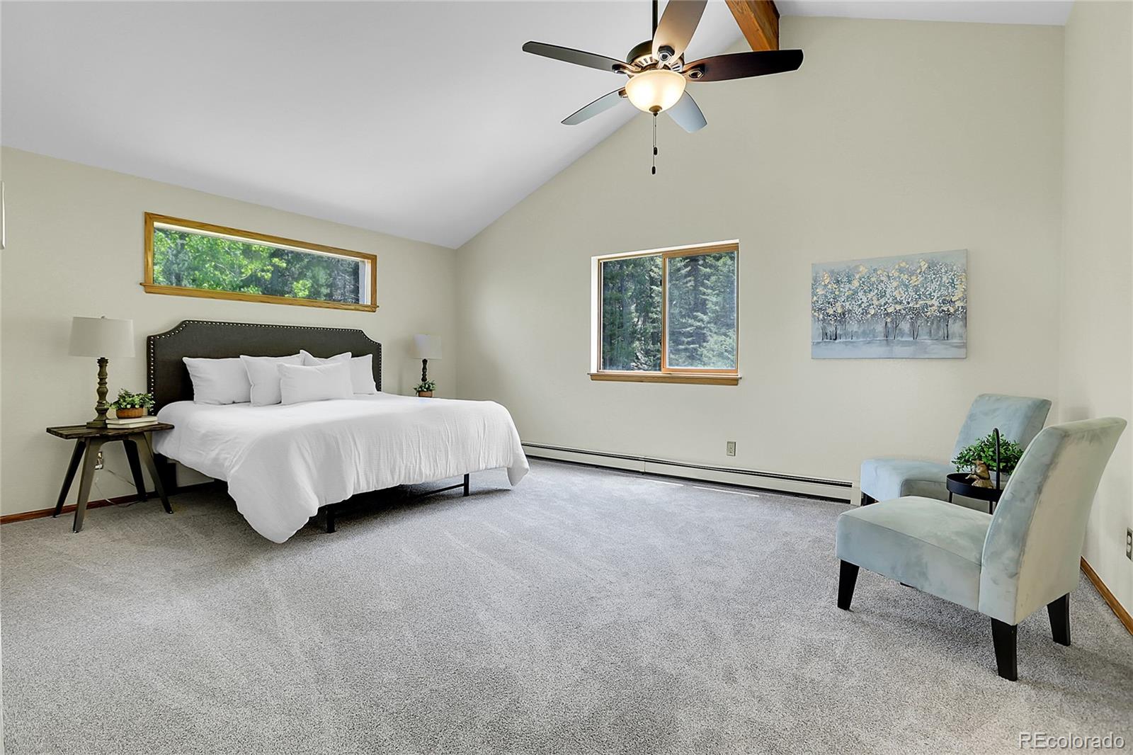 11333 Conifer Mountain Road Conifer, CO 80433 - Photo 26 of 50 a bedroom with a bed and a chandelier