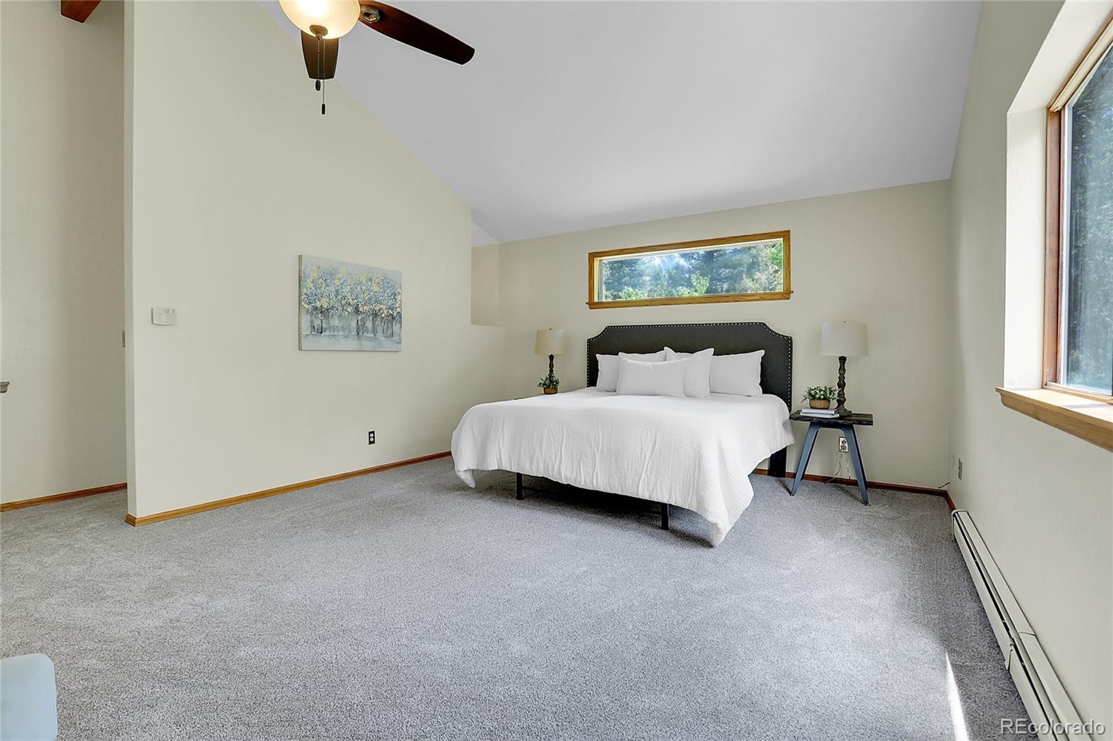 11333 Conifer Mountain Road Conifer, CO 80433 - Photo 27 of 50 a bedroom with a bed and a painting on the wall