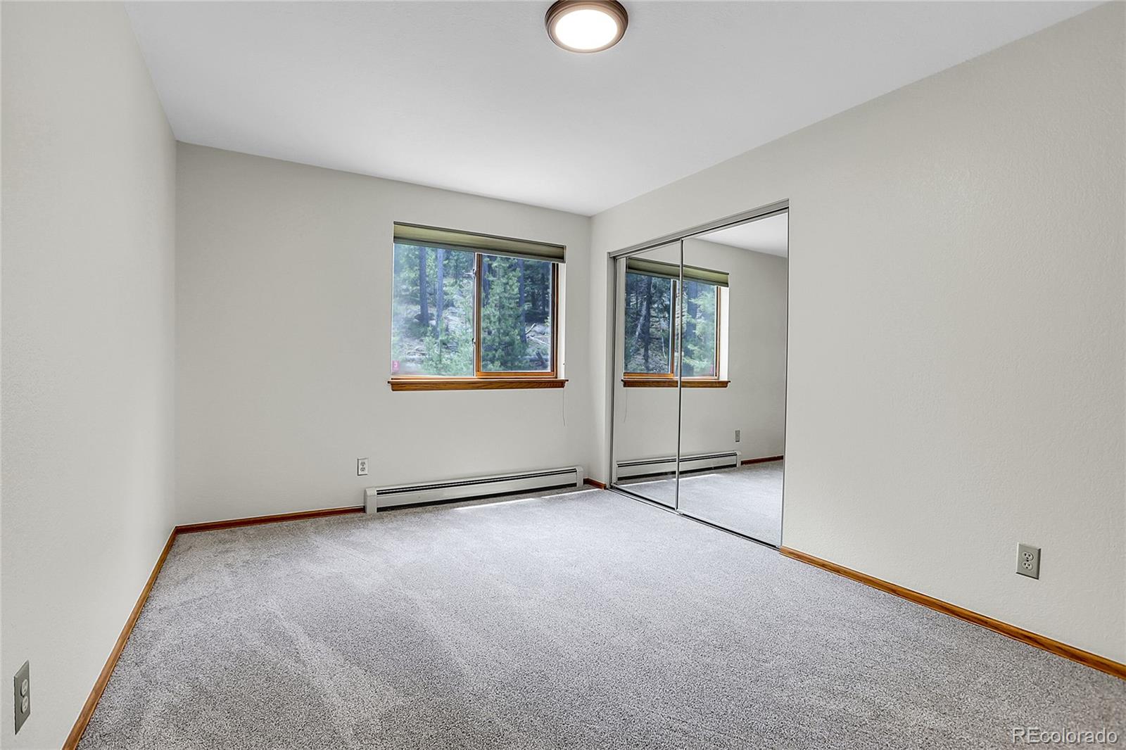 11333 Conifer Mountain Road Conifer, CO 80433 - Photo 33 of 50 an empty room with windows