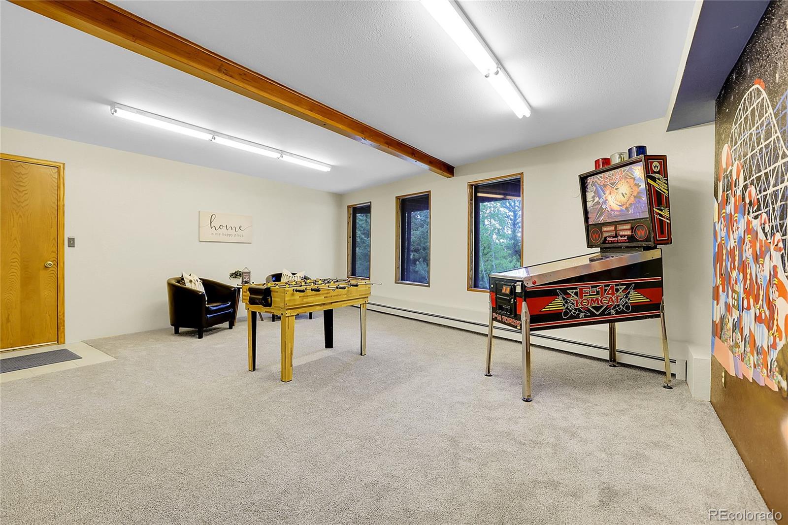 11333 Conifer Mountain Road Conifer, CO 80433 - Photo 38 of 50 a living room with furniture and a flat screen tv
