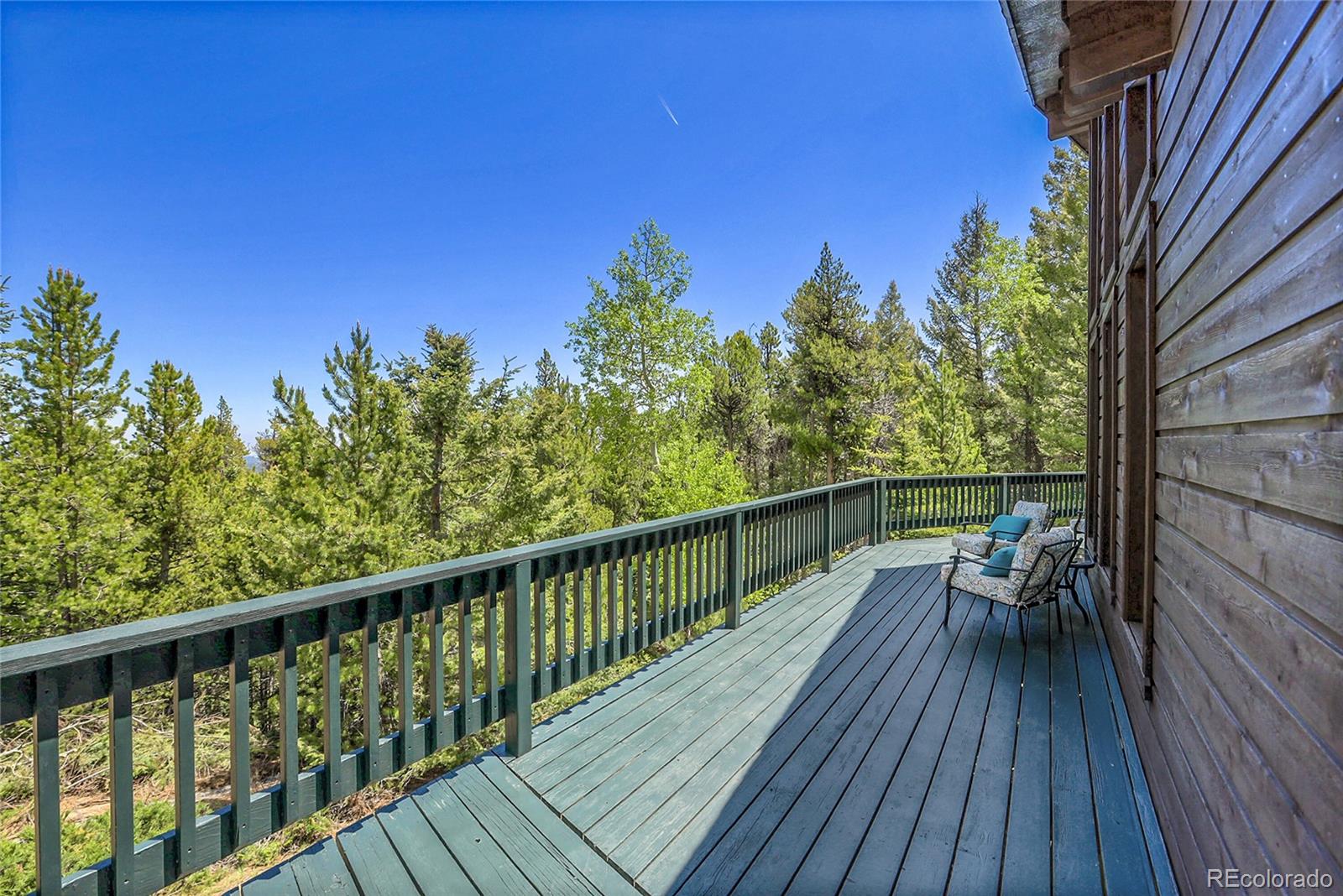 11333 Conifer Mountain Road Conifer, CO 80433 - Photo 8 of 50 a view of balcony with wooden floor and outdoor space