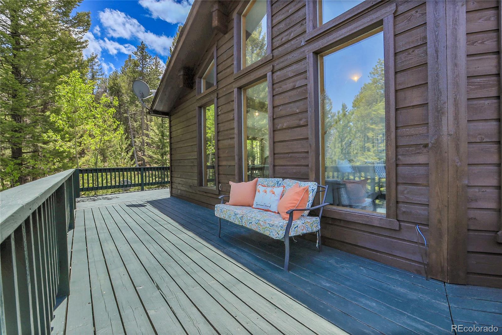 11333 Conifer Mountain Road Conifer, CO 80433 - Photo 9 of 50 a view of a wooden deck with a bench