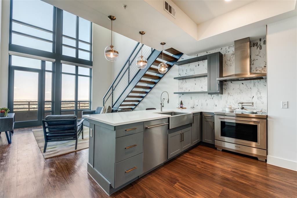 a kitchen with a stove and a wooden floors