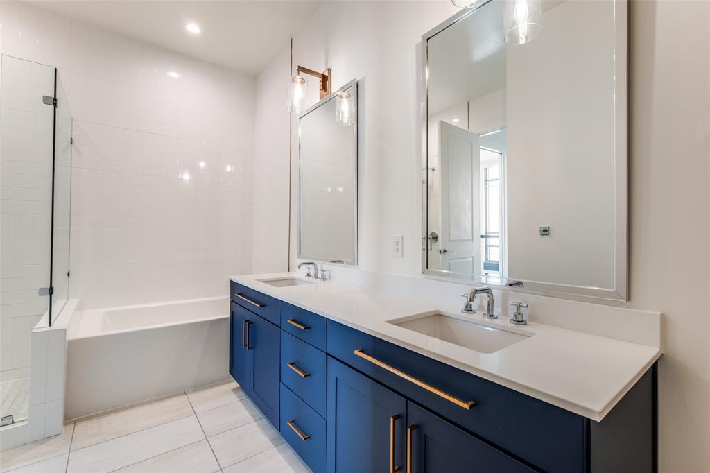 3611 Congress Avenue, Unit 2103 Dallas, TX 75219 - Photo 13 of 25 a bathroom with a sink double vanity granite tub shower and a mirror