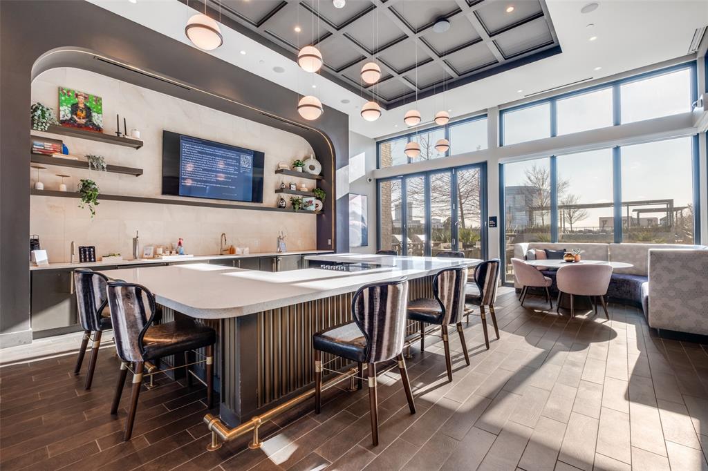 3611 Congress Avenue, Unit 2103 Dallas, TX 75219 - Photo 21 of 25 a view of a dining room with furniture a chandelier and wooden floor
