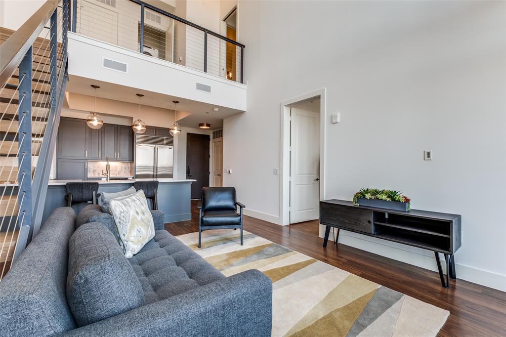 3611 Congress Avenue, Unit 2103 Dallas, TX 75219 - Photo 6 of 25 a living room with furniture and a rug