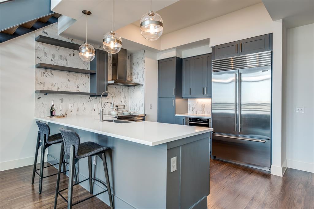 3611 Congress Avenue, Unit 2103 Dallas, TX 75219 - Photo 9 of 25 a kitchen with a sink and refrigerator