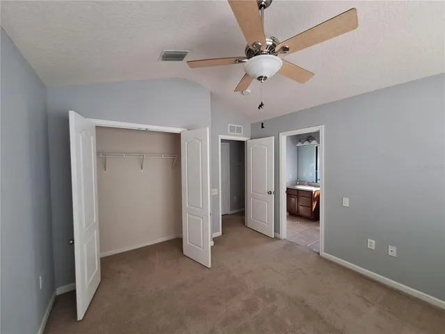 a view of a livingroom with a ceiling fan & a ceiling fan