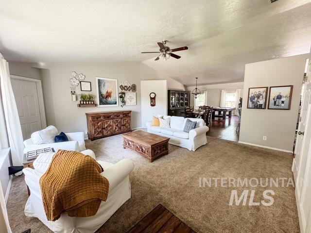 808 O'Leary Way Twin Falls, ID 83301 - Photo 5 of 37 Expansive living area featuring vaulted ceilings with a ceiling fan, carpet flooring, and neutral wall tones