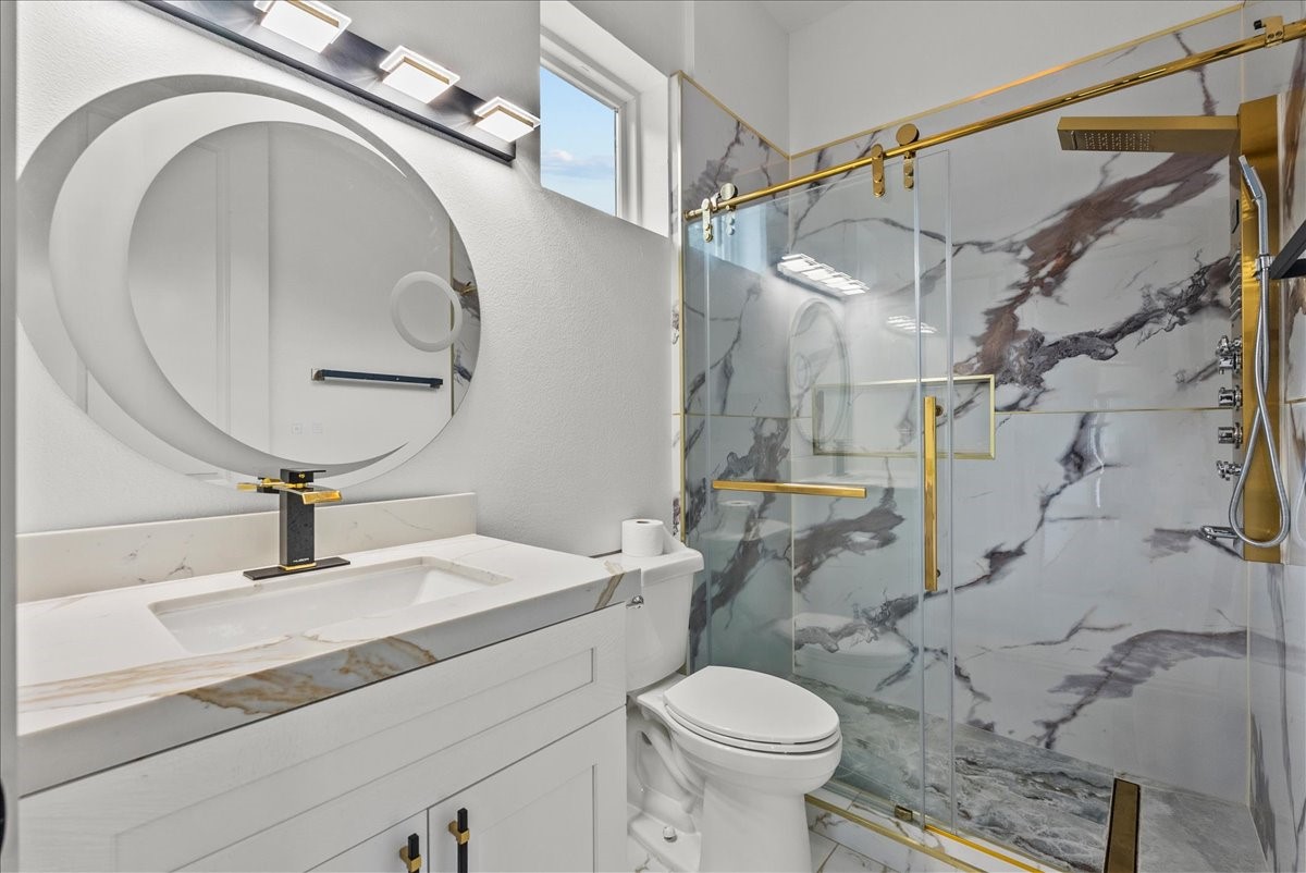 3237 Harkey Road Pearland, TX 77584 - Photo 38 of 46 Luxury bathroom with designer lighting, modern vanity, and oversized custom shower.
