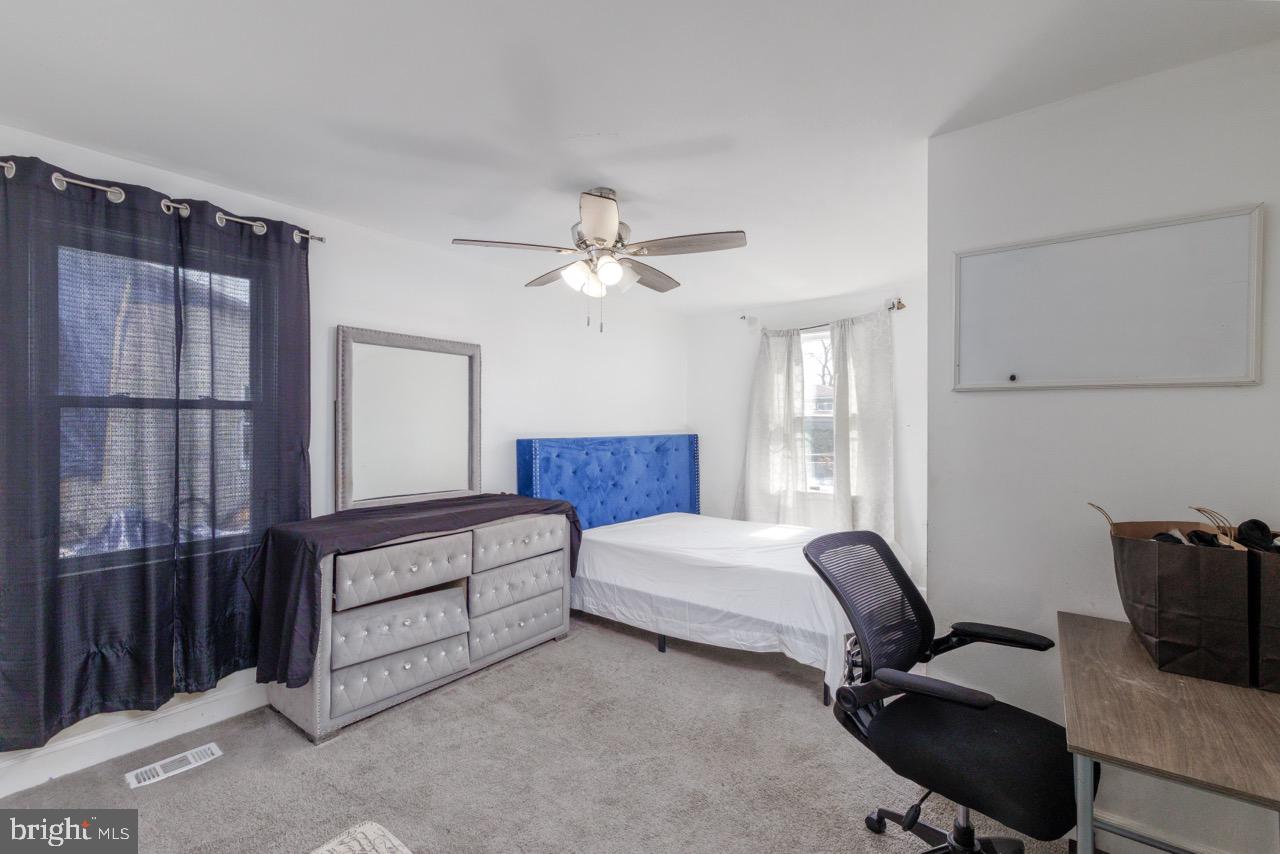 812 Silver Avenue Baltimore, MD 21221 - Photo 11 of 21 a bedroom with a bed and a chandelier