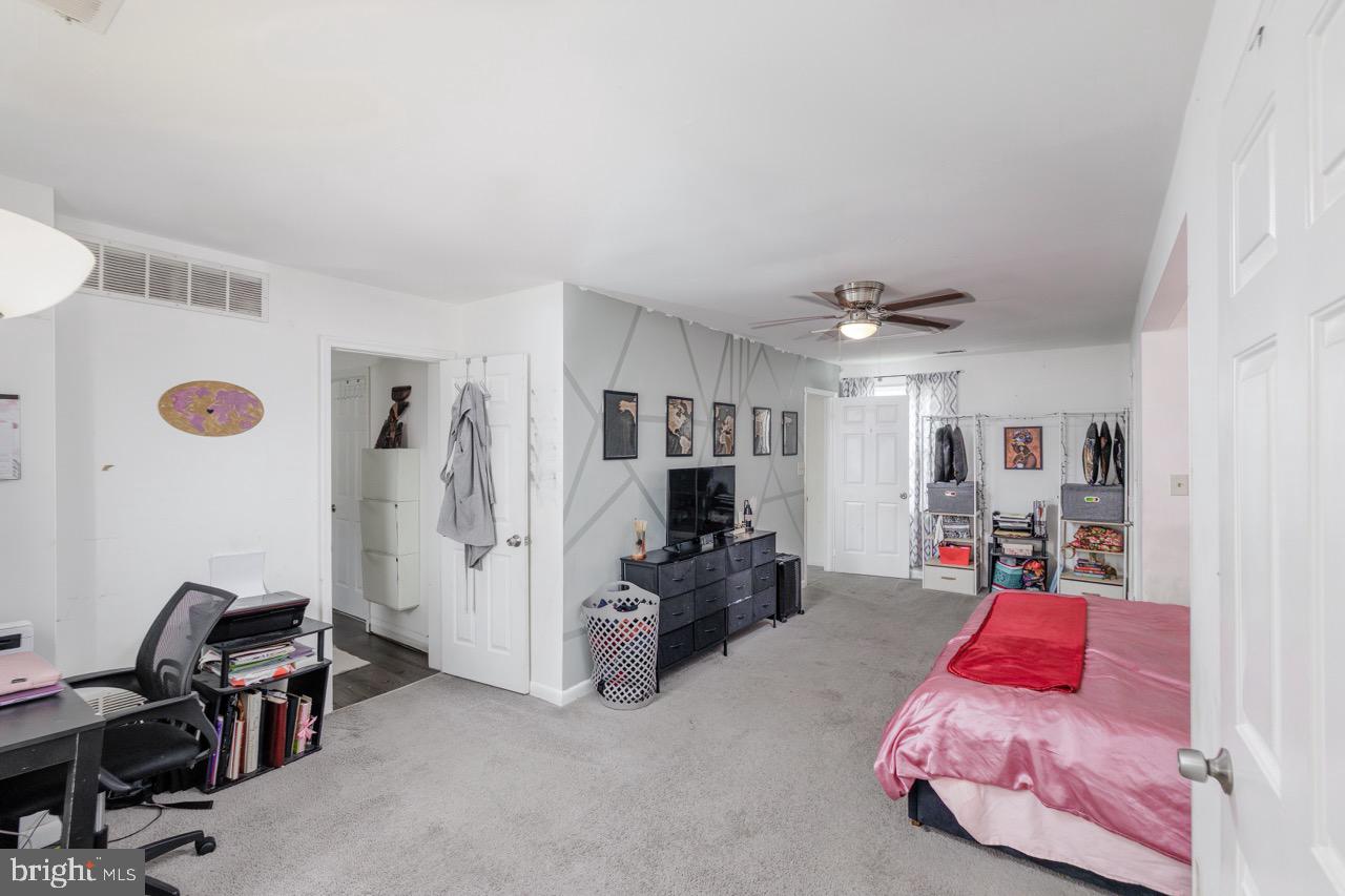 812 Silver Avenue Baltimore, MD 21221 - Photo 16 of 21 a bedroom with furniture and a chandelier