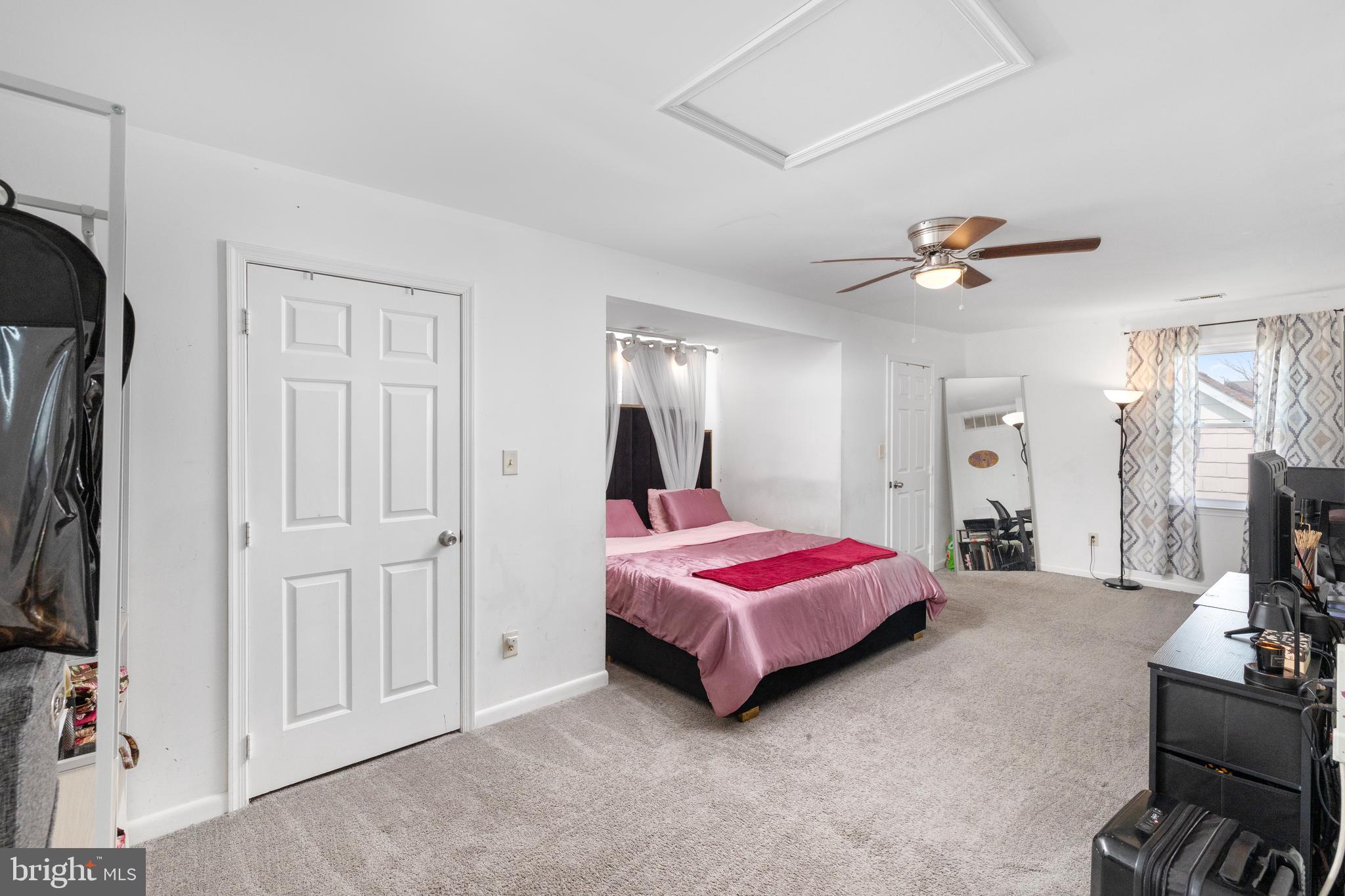 812 Silver Avenue Baltimore, MD 21221 - Photo 17 of 21 a spacious bedroom with a bed a mirror and dresser