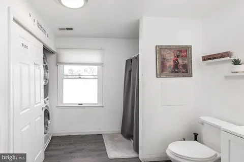 a white toilet sitting next to a bathroom sink and tub